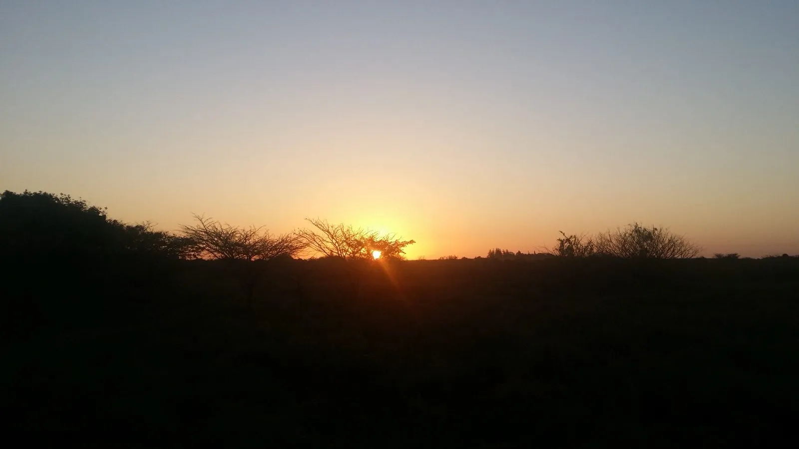 The sun coming up over the hills