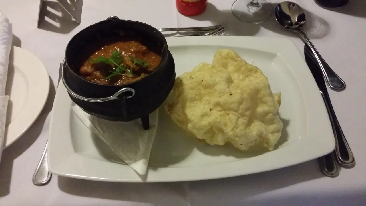 Lamb curry served in a little potjie pot