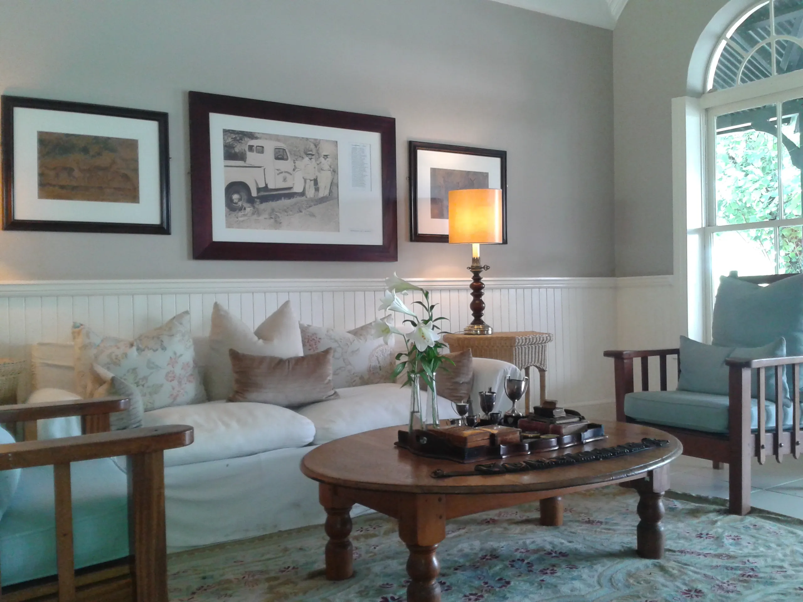 The lodge lounge — deep sofas, framed prints and colonial timber