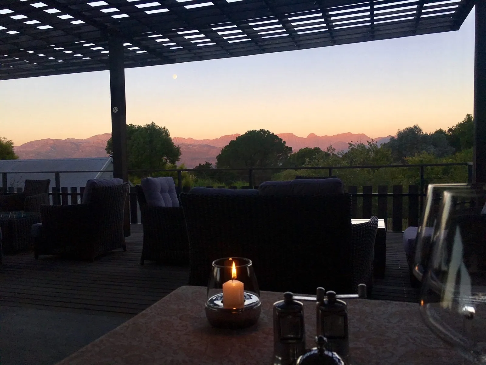 The terrace at dusk with a candle burning