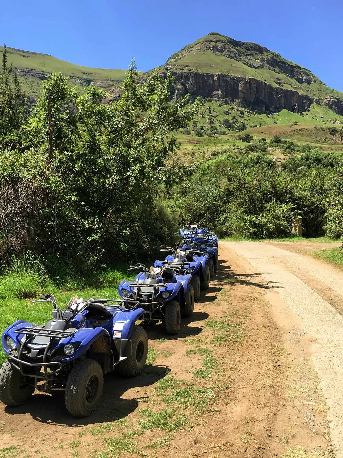 Quad bikes lined up on a gravel track ready to go out