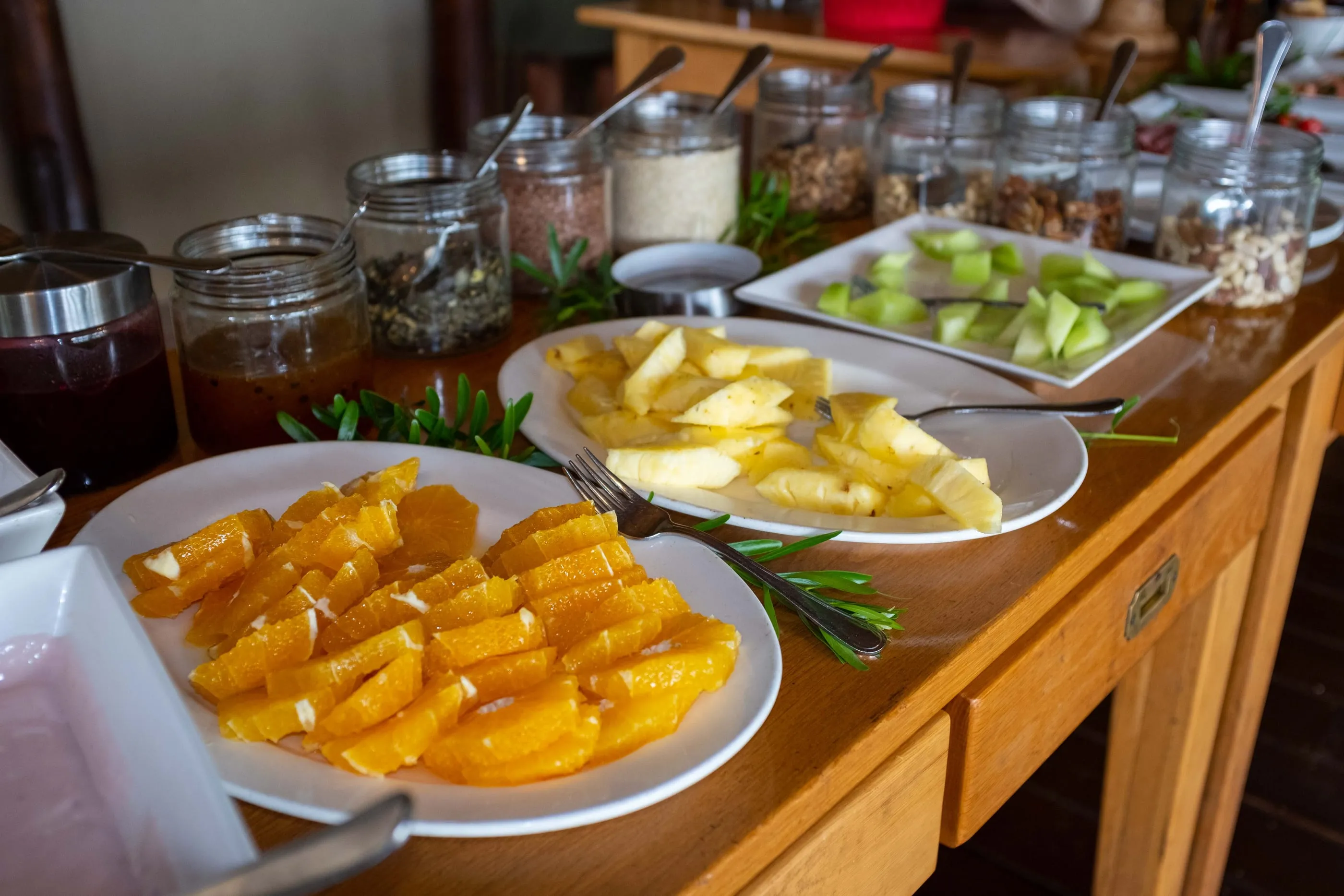 Breakfast laid out — fresh fruit and preserves on a wooden sideboard