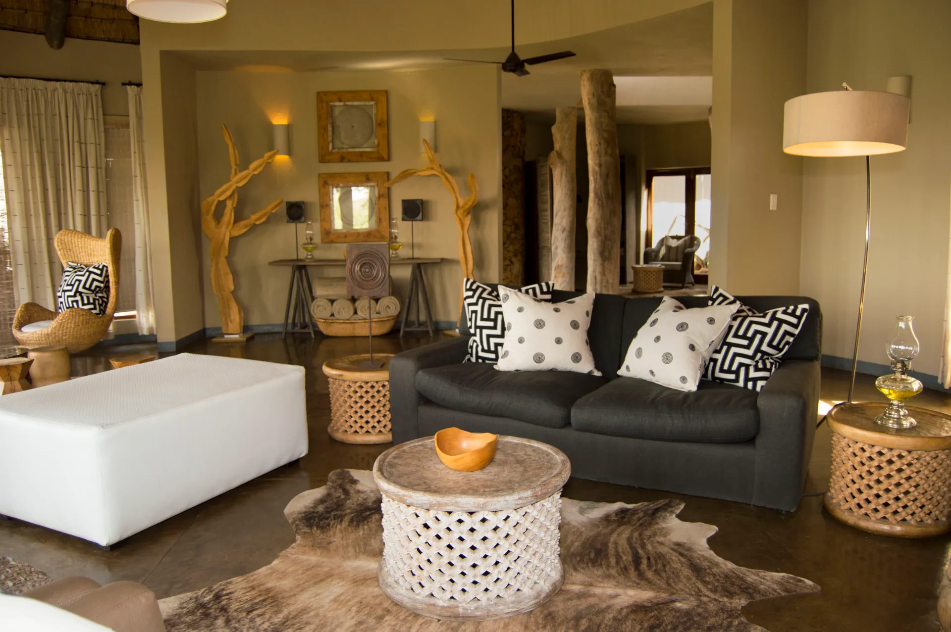 The suite's lounge, all pale linen and dark timber