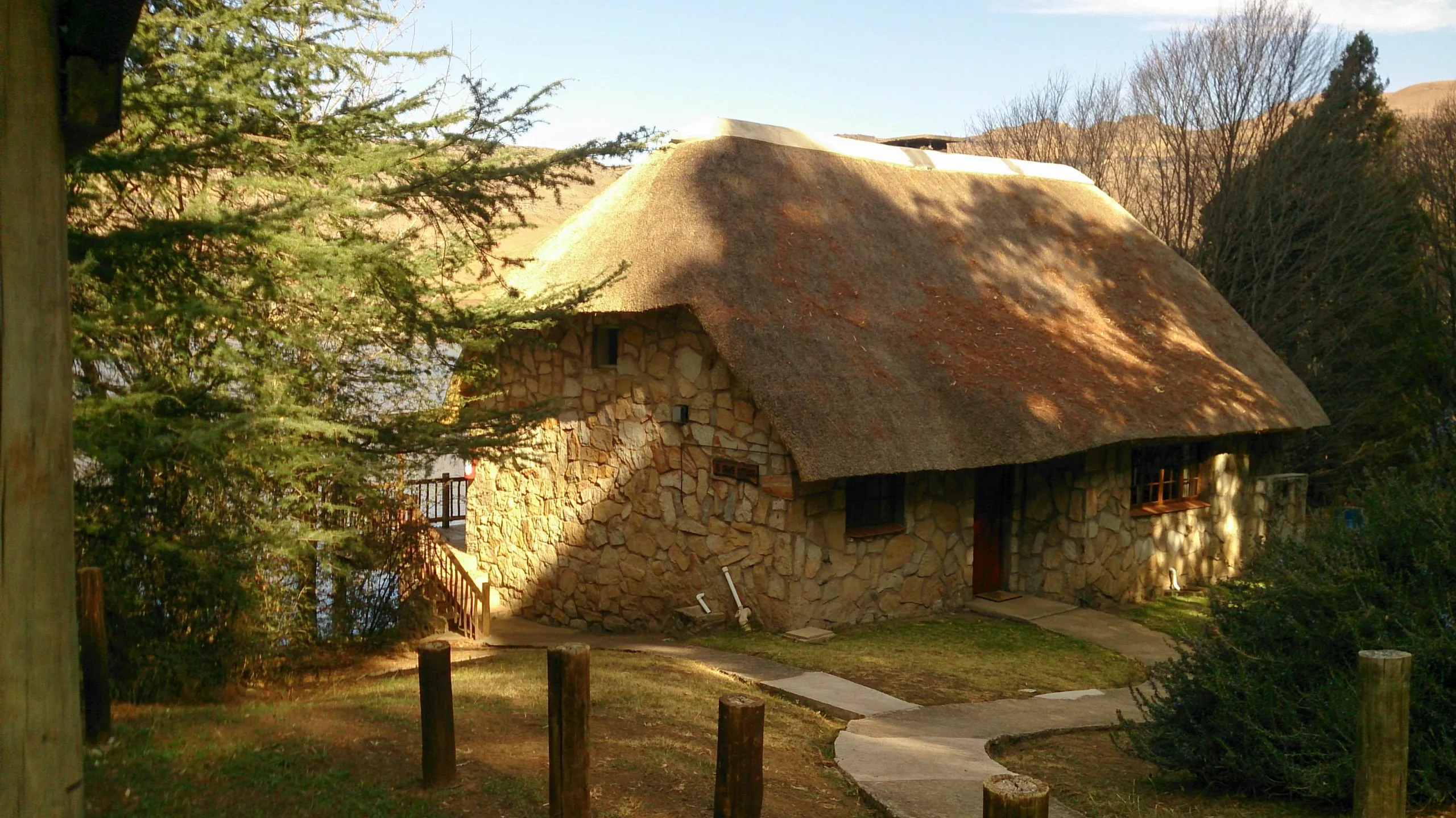 A thatched chalet tucked in among the trees