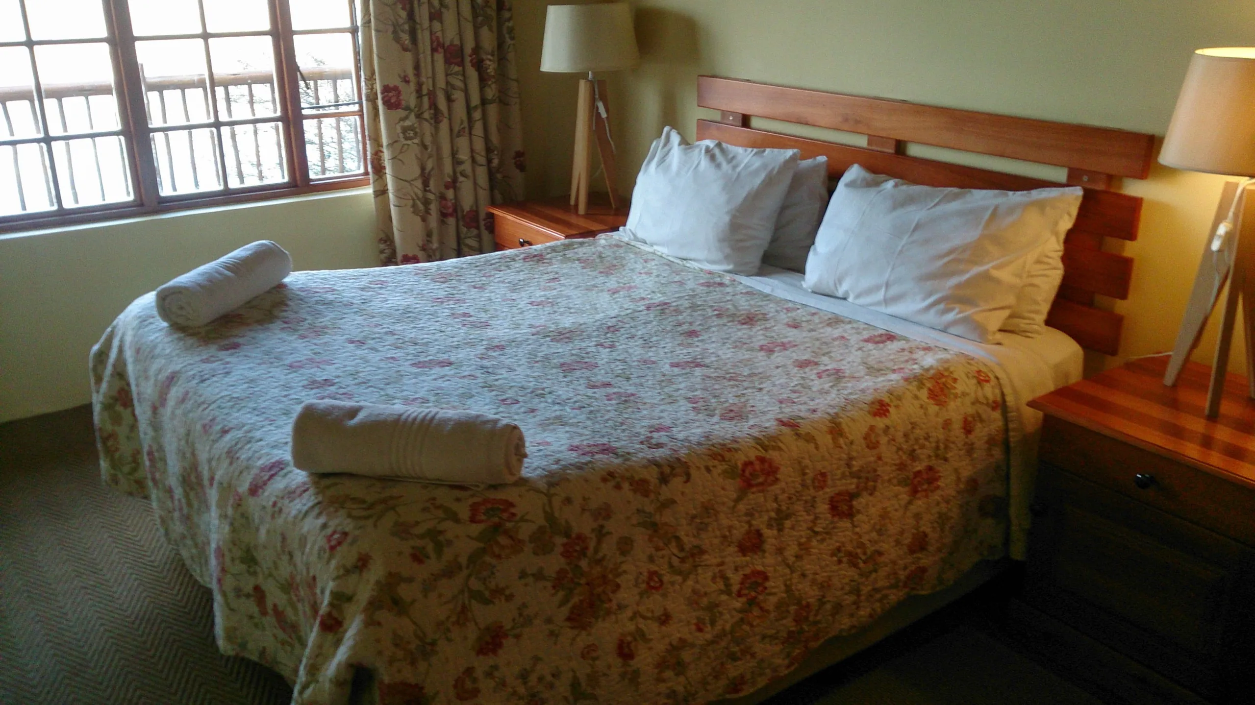 The bedroom, made up and looking out to the water