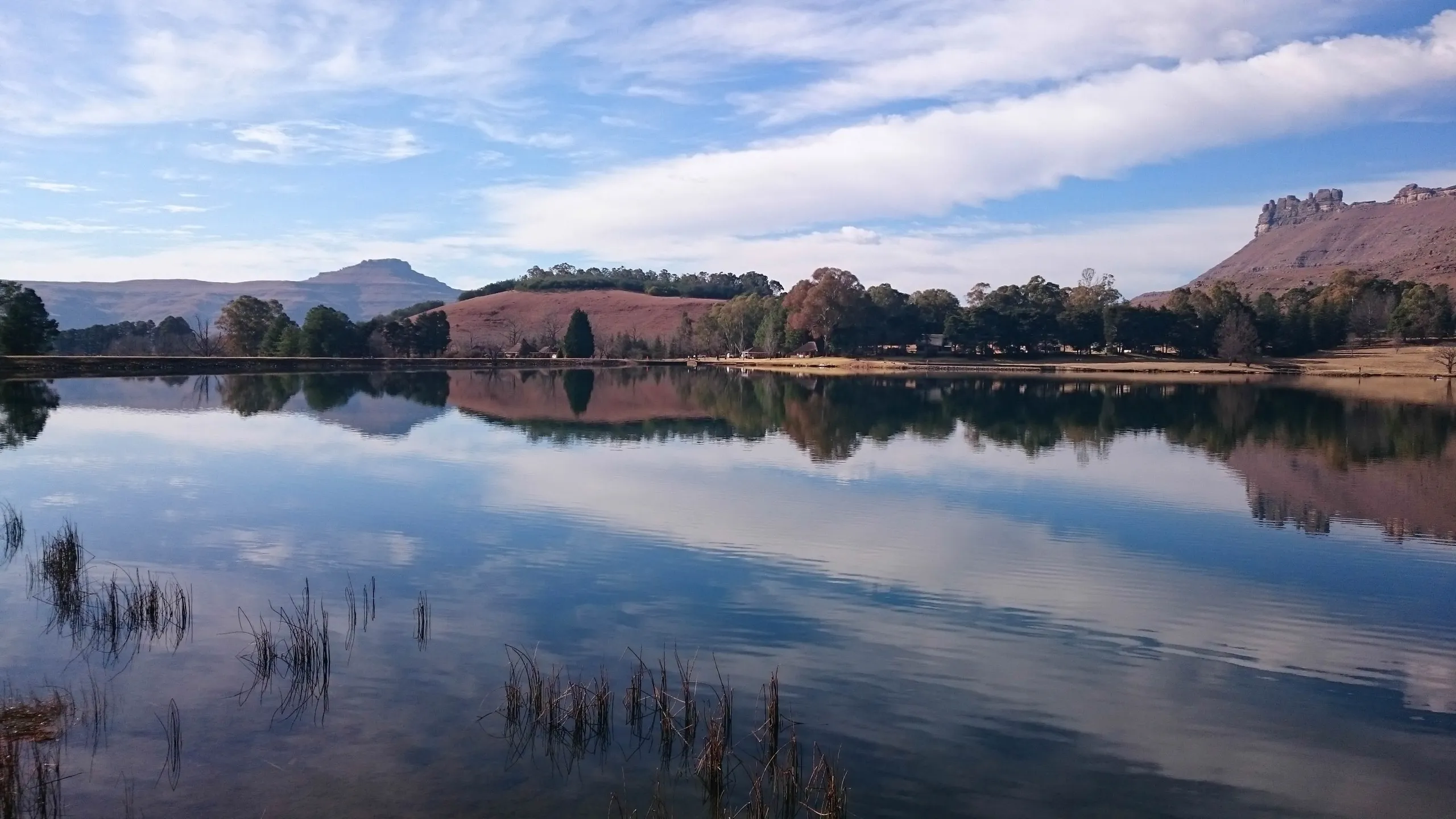 The berg reflected in the flat calm of the lake