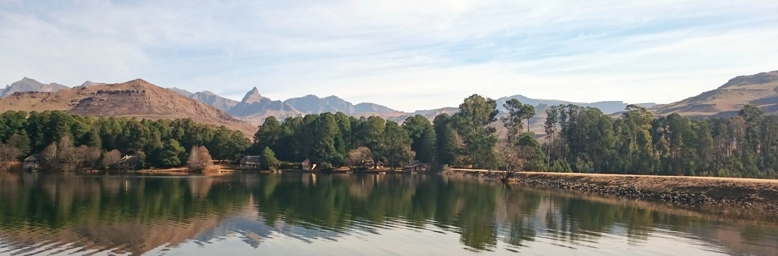 The lake lying still beneath the foothills of the southern Drakensberg