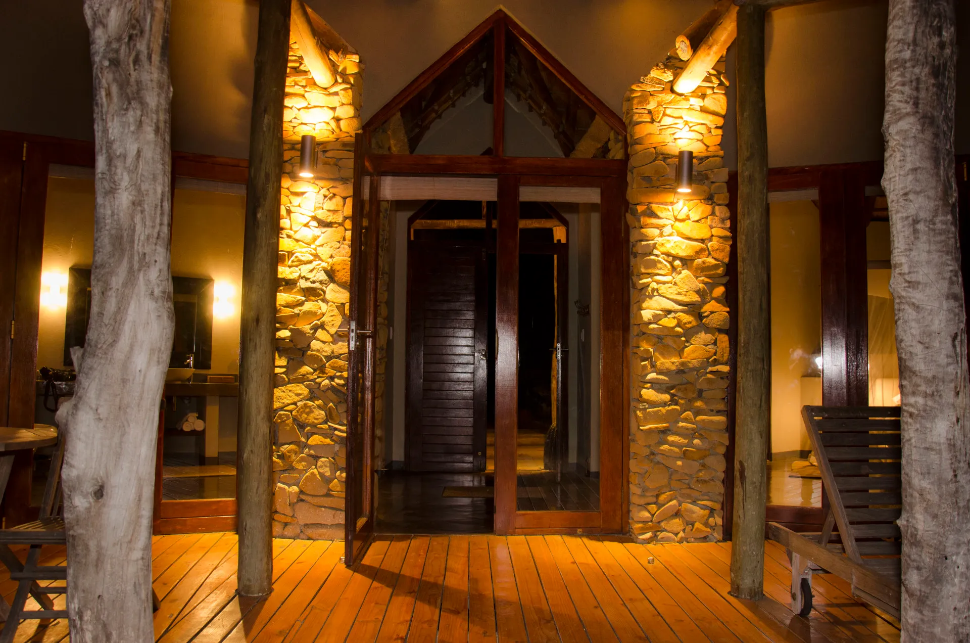 The lodge entrance lit warm against the stone and timber at dusk