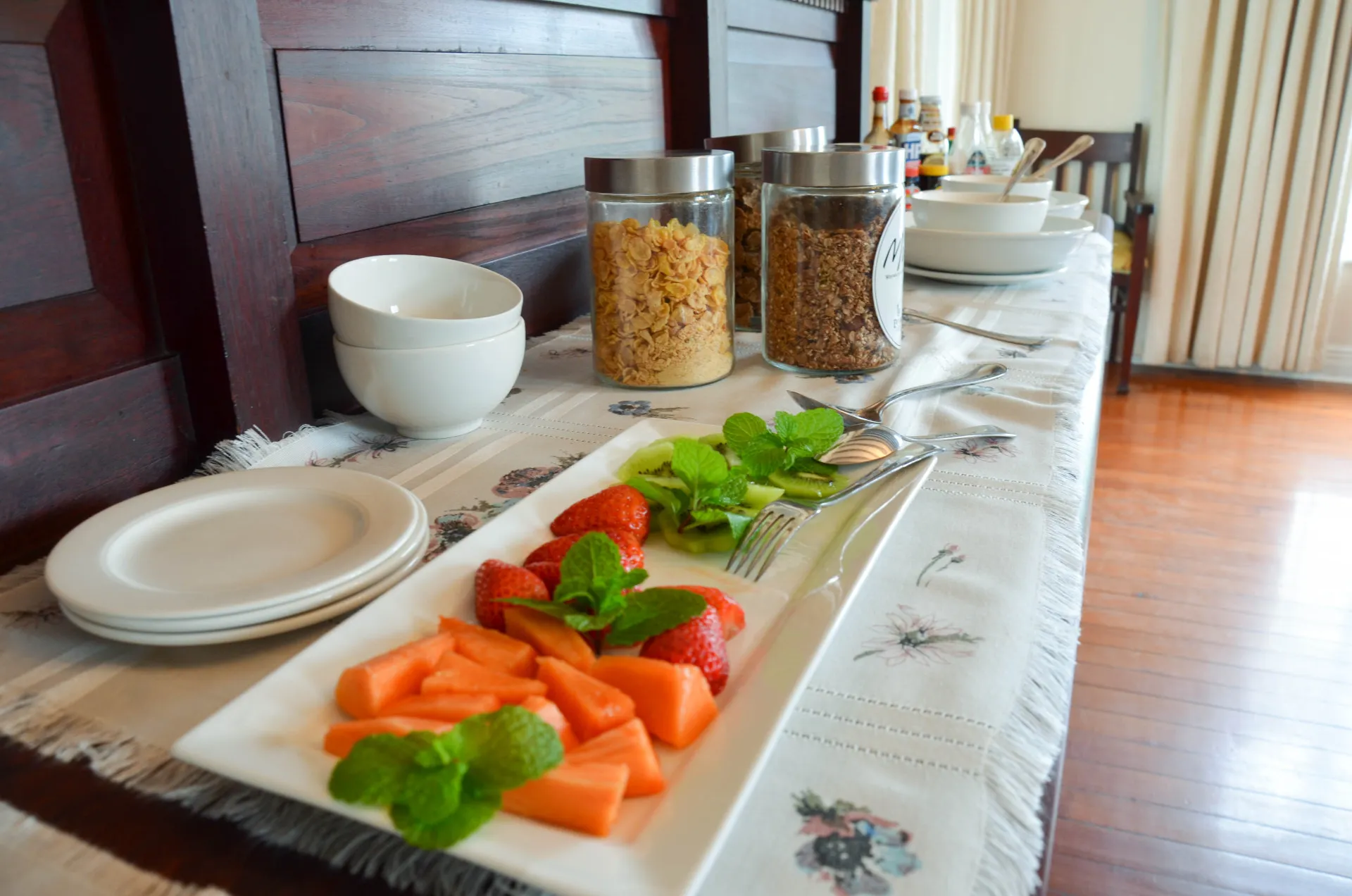 Breakfast laid out along the sideboard — fruit, cereals and preserves