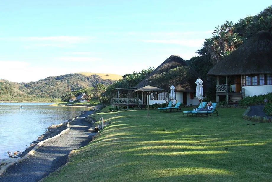 Bungalows on the green bank above the Umngazi river mouth
