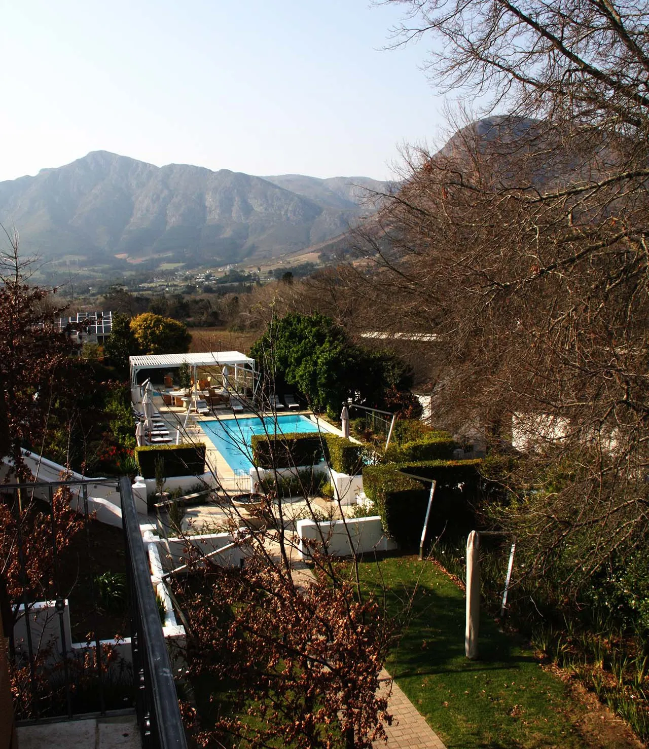 The hotel gardens and pool below the Franschhoek mountains