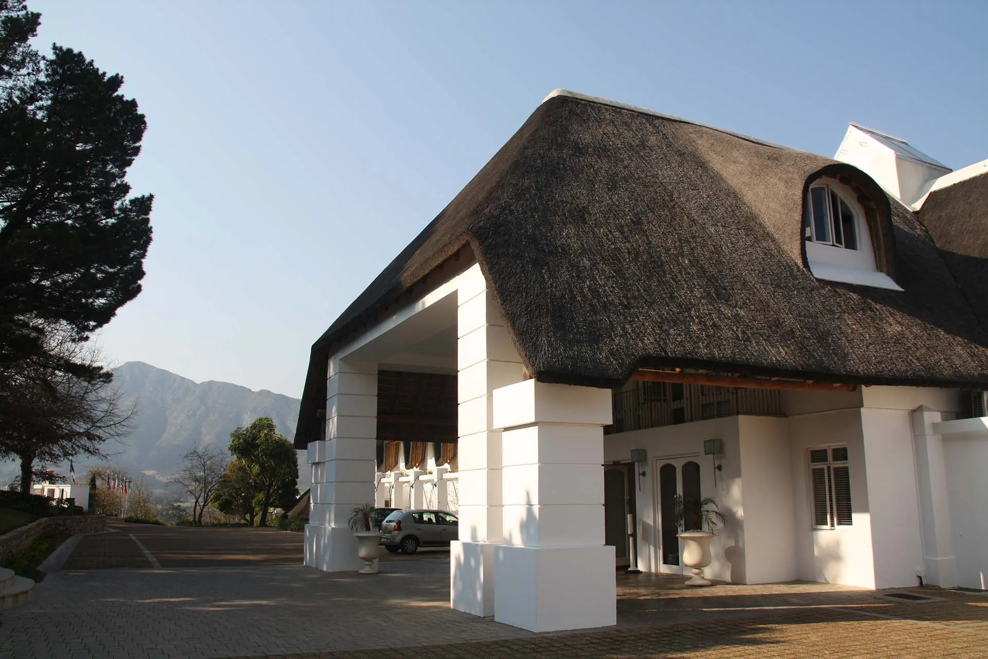 The thatched entrance building at the top of the drive