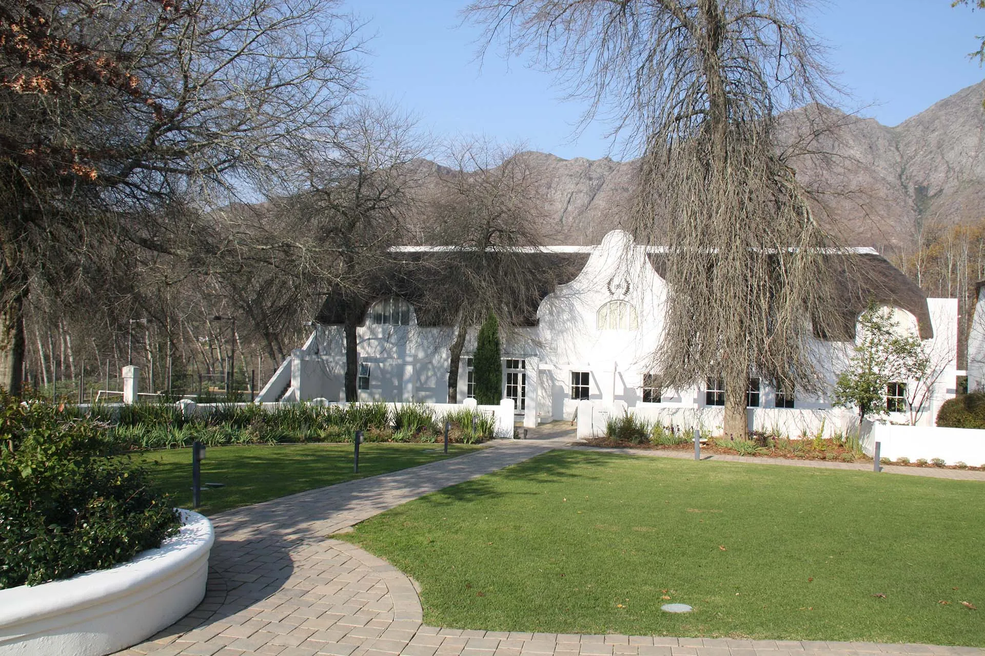 The white gabled frontage of the hotel across its lawn