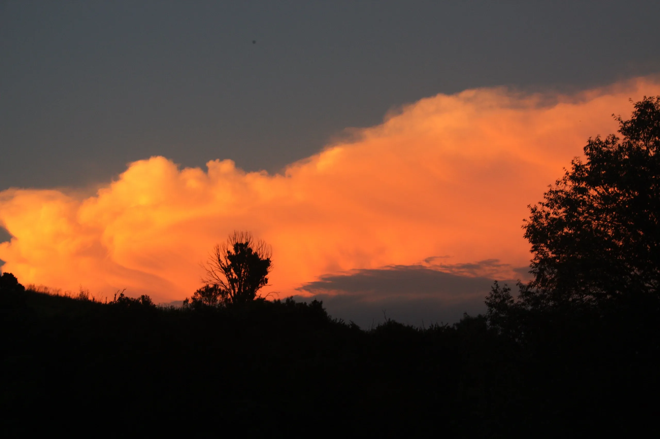 Cloud over the Kamberg escarpment burning orange at sunset