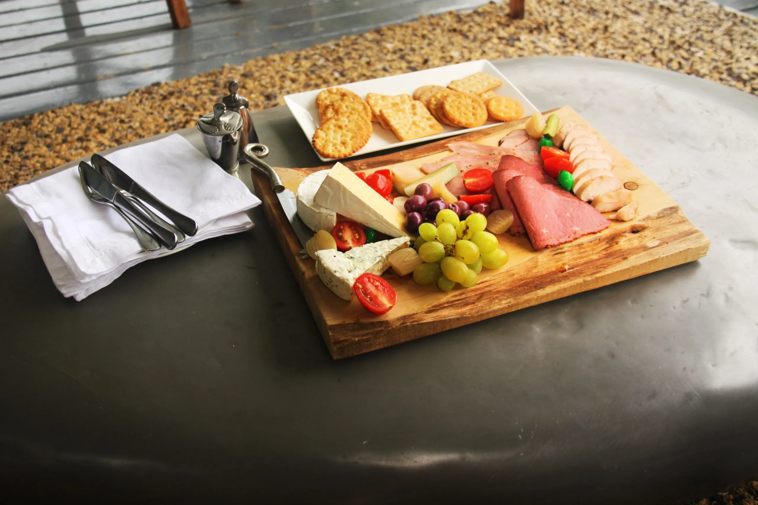 A cheese and biscuit platter served out on the deck