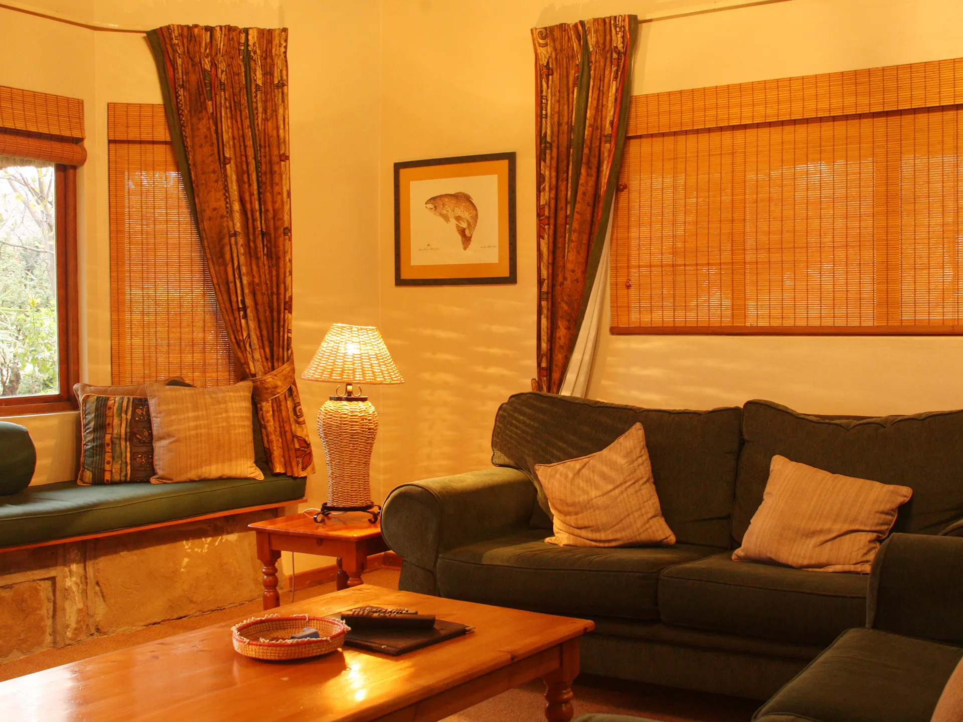 The lounge inside the suite, lamp-lit and warm