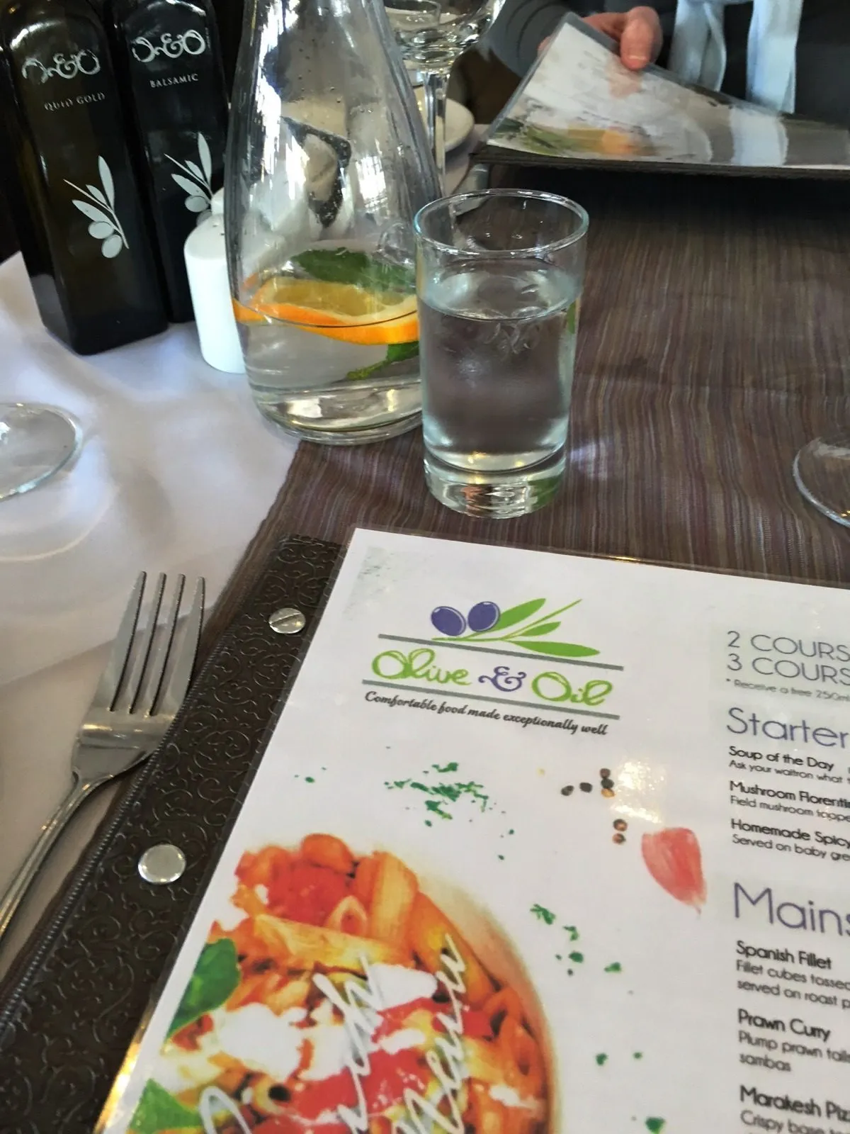 A pizza and a cold glass of water