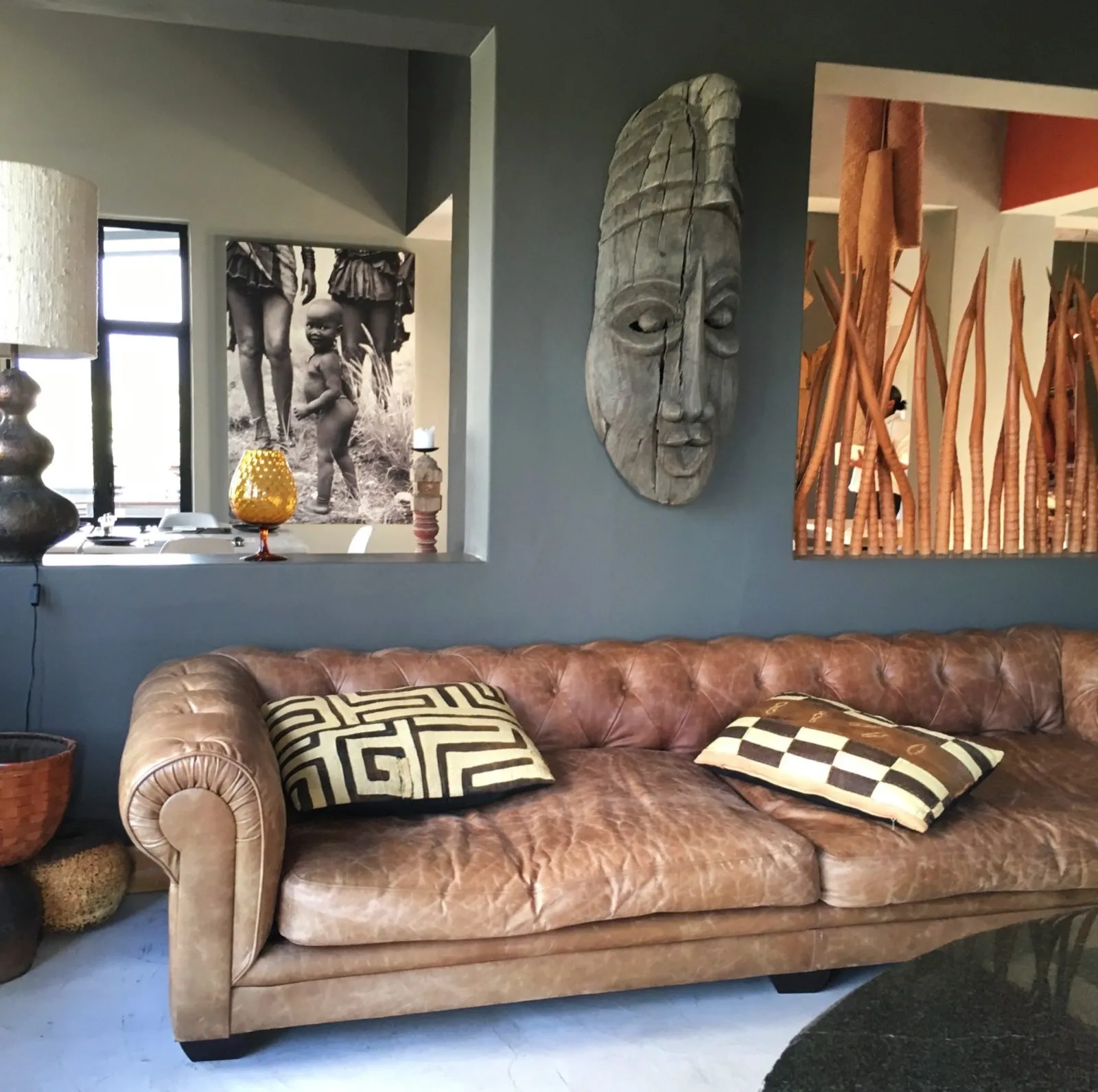 The lounge, leather sofa and carved masks