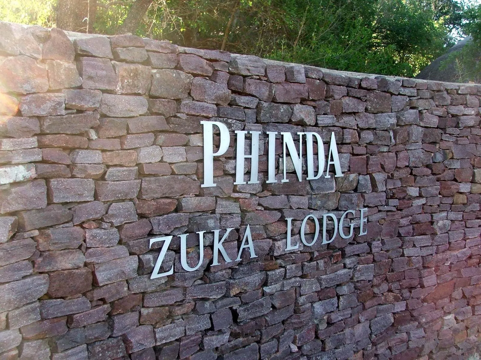 The Phinda Zuka Lodge sign cut into stone