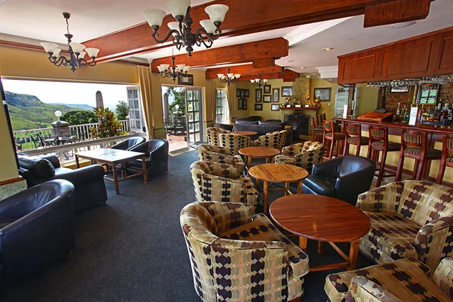 The lounge and bar, with armchairs looking out to the mountains