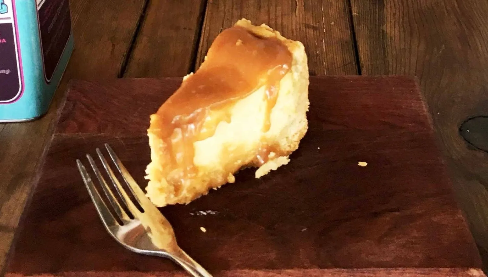 A slice of tart served on a wooden board