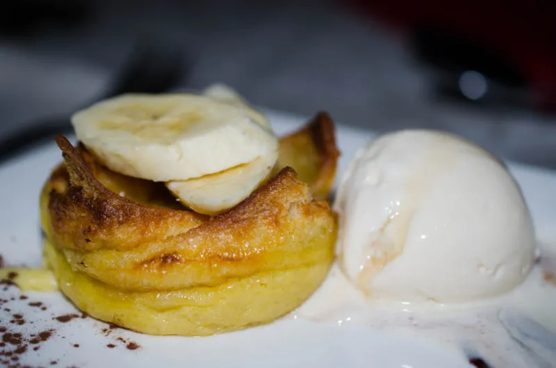 A warm baked dessert served with a scoop of ice cream
