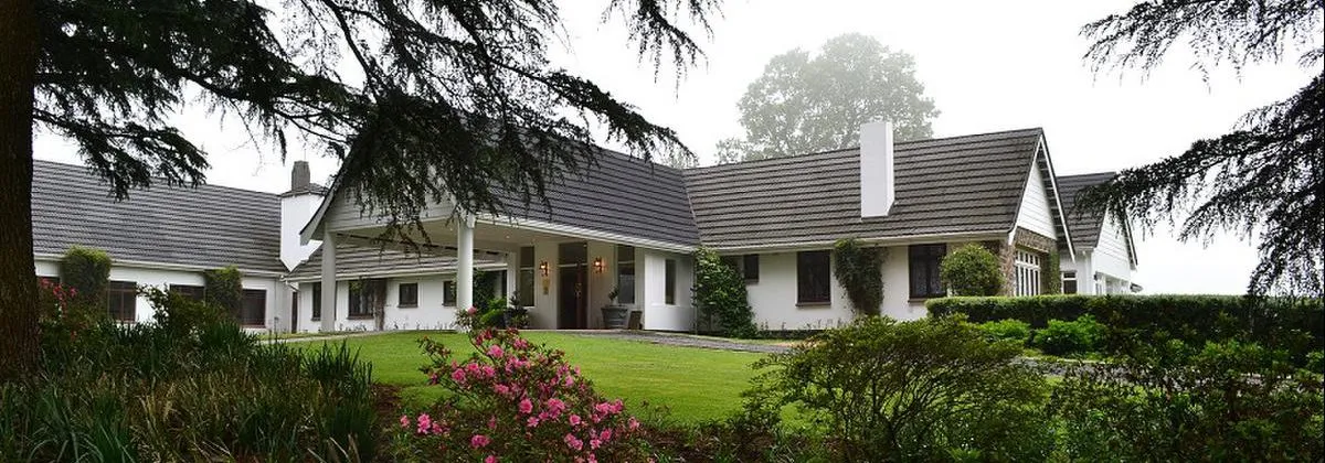 The long low lodge building seen across its lawn